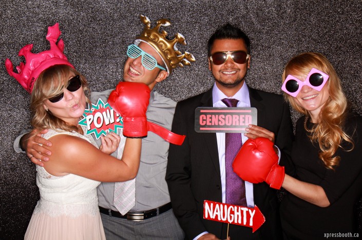Cool group using photo booth props: censored sign, boxing gloves, inflatable crown and pow sign