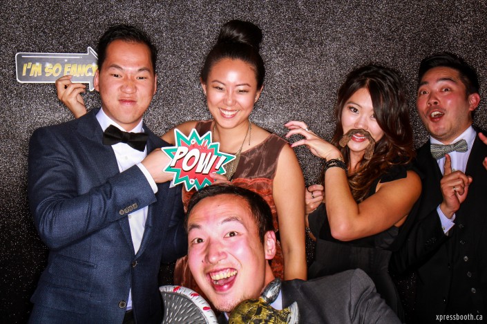 A group of friends doing funny poses in the photo booth