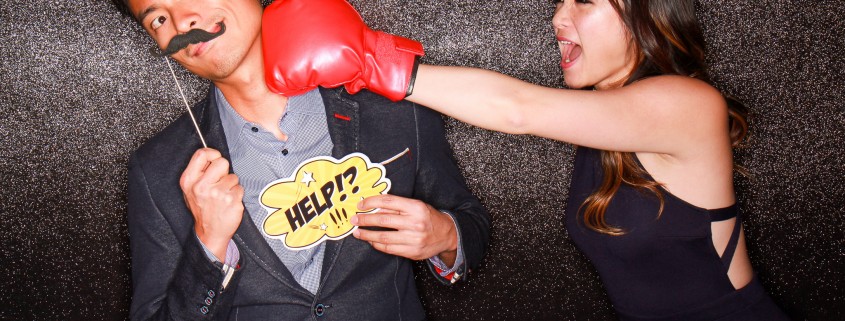 Guy getting punched by pretty girl holding up a help sign and moustache